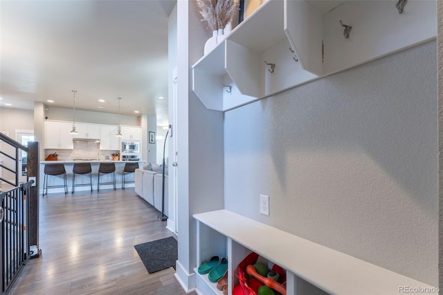 21574 E 59th Dr, Aurora, CO 80019 - mudroom with wood finished floors, recessed lighting, a textured wall, and baseboards