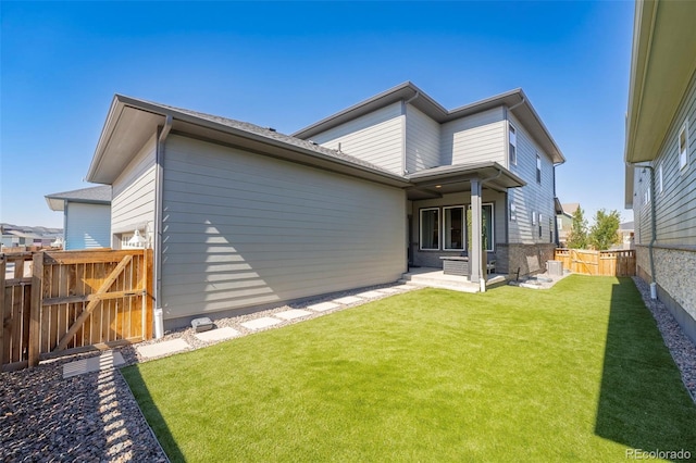 21574 E 59th Dr, Aurora, CO 80019 - rear view of property with a gate and a patio