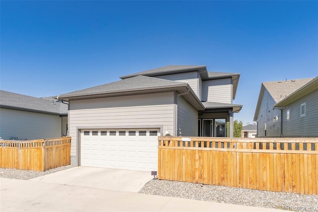 21574 E 59th Dr, Aurora, CO 80019 - prairie-style house featuring an attached garage, fence, and concrete driveway