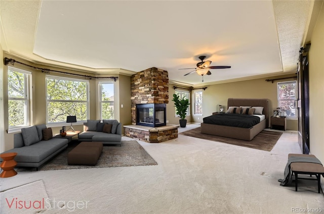 2950 Wyecliff Ln, Highlands Ranch, CO 80126 - bedroom featuring multiple windows, ornamental molding, a stone fireplace, and carpet floors