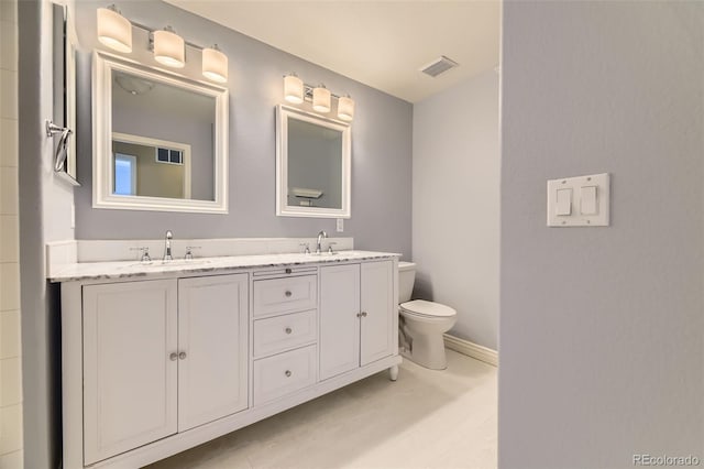 2950 Wyecliff Ln, Highlands Ranch, CO 80126 - full bathroom with double vanity, toilet, and baseboards