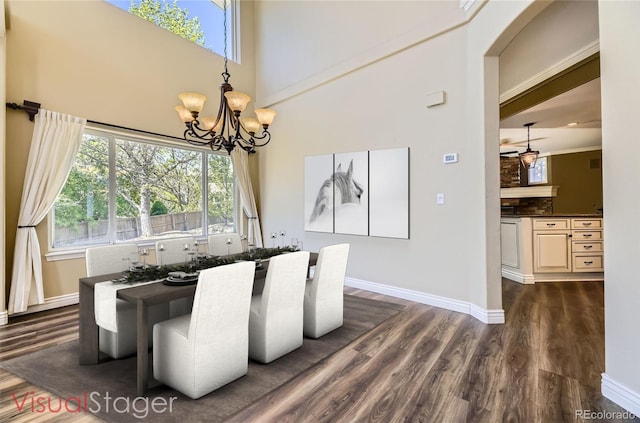 2950 Wyecliff Ln, Highlands Ranch, CO 80126 - dining area featuring dark wood-style flooring, a chandelier, baseboards, plenty of natural light, and a towering ceiling