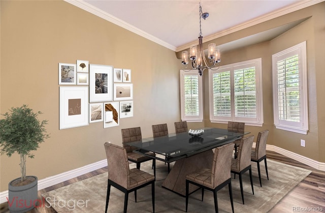 2950 Wyecliff Ln, Highlands Ranch, CO 80126 - dining area with baseboards, wood finished floors, a chandelier, and crown molding