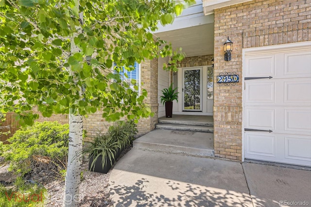 2950 Wyecliff Ln, Highlands Ranch, CO 80126 - doorway to property with brick siding and a garage