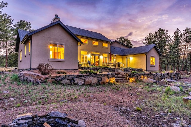 459 County Road 85, Guffey, CO 80820 - back of property featuring a chimney, stairway, and stucco siding