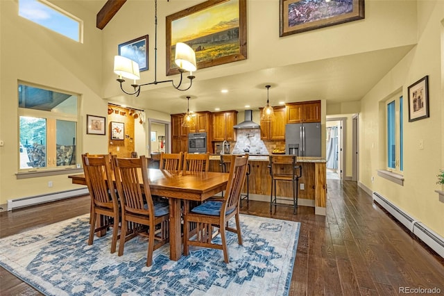 459 County Road 85, Guffey, CO 80820 - dining space featuring baseboard heating, high vaulted ceiling, a baseboard heating unit, dark wood-type flooring, and baseboards