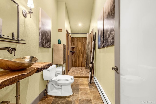 459 County Road 85, Guffey, CO 80820 - bathroom with a baseboard radiator, toilet, a sink, and baseboards