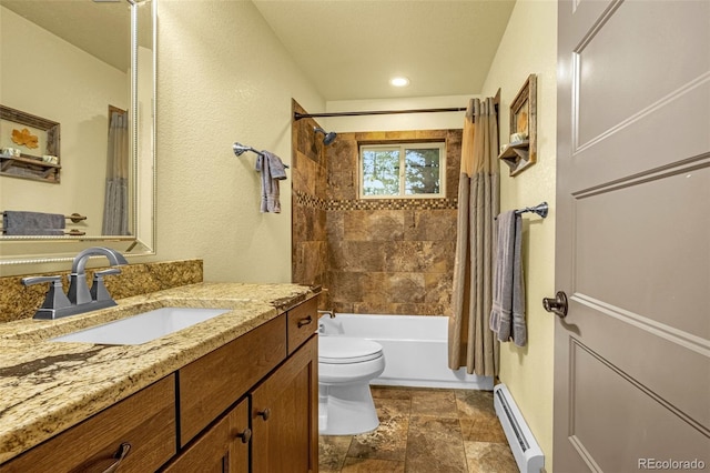 459 County Road 85, Guffey, CO 80820 - bathroom featuring baseboard heating, vanity, toilet, stone finish floors, and shower / bath combo