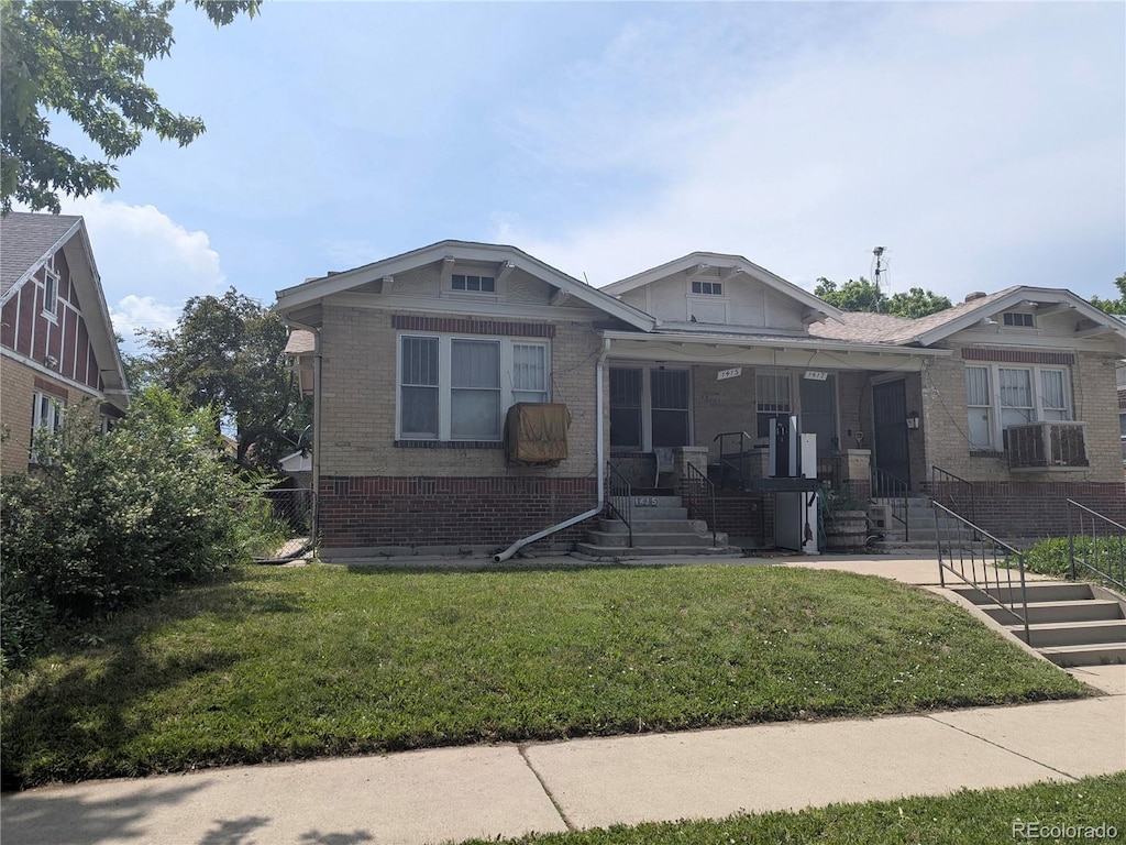 1415 Raleigh St, Denver, CO 80204 - bungalow-style house with brick siding, a front lawn, and a porch