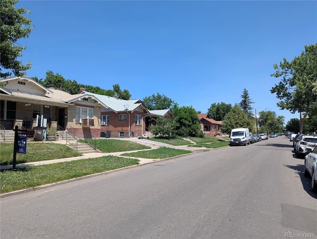 1415 Raleigh St, Denver, CO 80204 - view of asphalt road with sidewalks, curbs, and a residential view