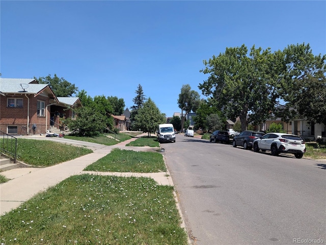 1415 Raleigh St, Denver, CO 80204 - view of asphalt road with sidewalks, curbs, and a residential view