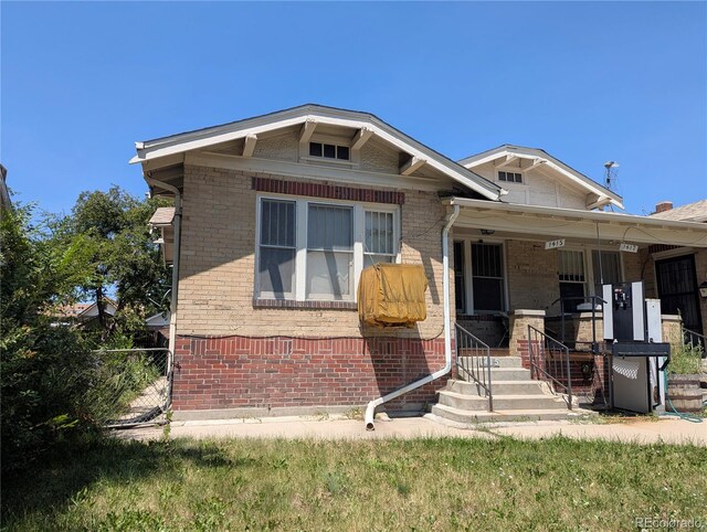 1415 Raleigh St, Denver, CO 80204 - bungalow-style home with brick siding and a porch
