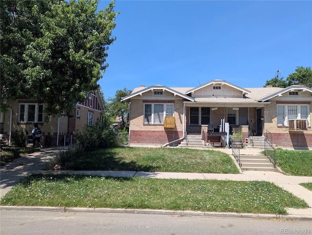 1415 Raleigh St, Denver, CO 80204 - bungalow with brick siding, covered porch, and a front yard