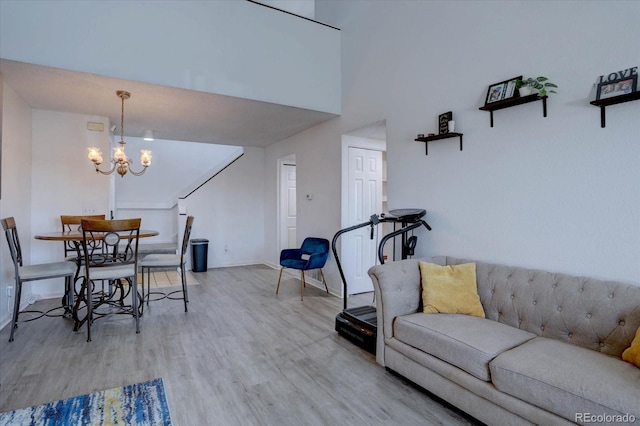 11115 E Alameda Ave Unit 201, Aurora, CO 80012 - living room featuring baseboards, an inviting chandelier, and wood finished floors
