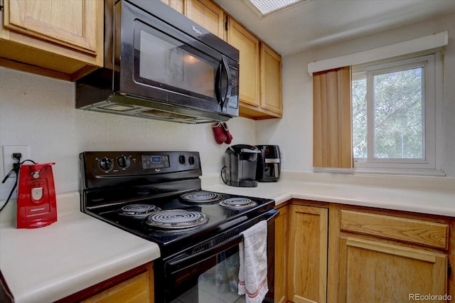 11115 E Alameda Ave Unit 201, Aurora, CO 80012 - kitchen featuring light countertops and black appliances