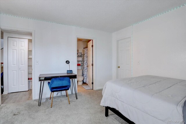 11115 E Alameda Ave Unit 201, Aurora, CO 80012 - bedroom featuring baseboards, a textured ceiling, and light colored carpet