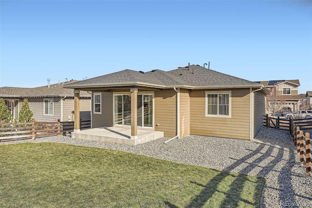 rear view of house featuring a lawn and a patio area