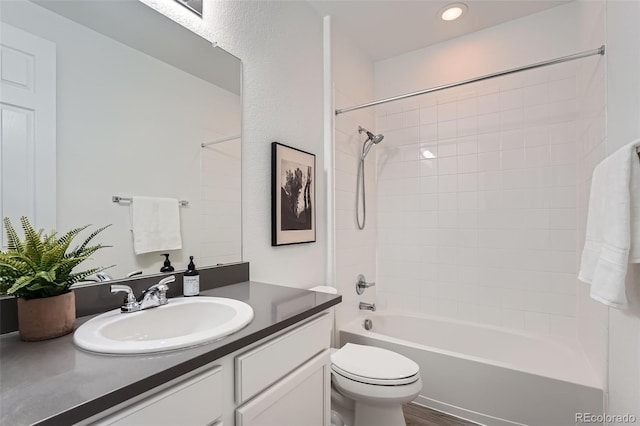 full bathroom with vanity, toilet, and tiled shower / bath combo