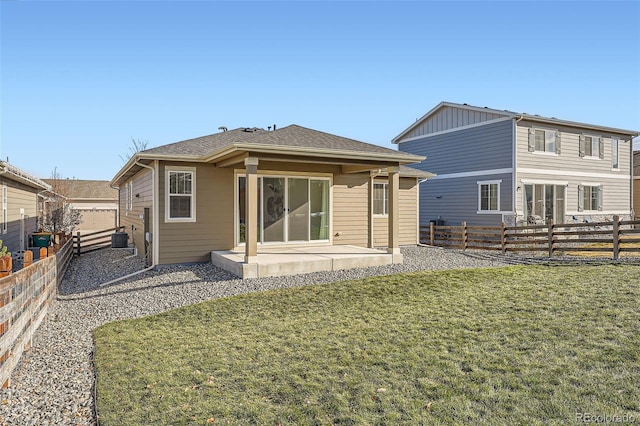 rear view of house with a patio area, a yard, and central AC