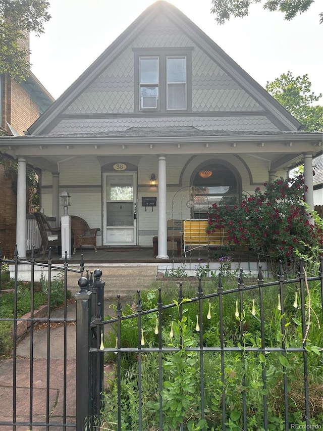 36 N Logan St, Denver, CO 80203 - victorian-style house with covered porch and a fenced front yard