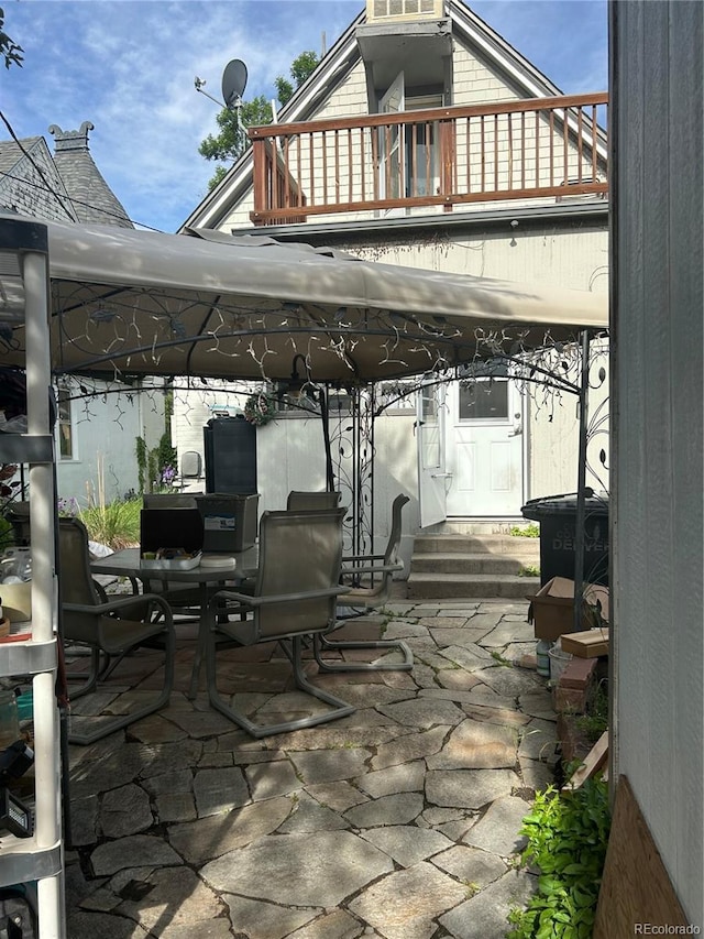 36 N Logan St, Denver, CO 80203 - view of patio featuring a balcony, entry steps, and outdoor dining space
