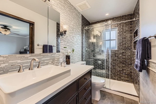 6646 S Fundy Ct, Centennial, CO 80016 - bathroom with toilet, vanity, a stall shower, tile walls, and decorative backsplash