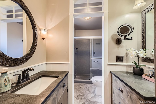 6646 S Fundy Ct, Centennial, CO 80016 - full bathroom featuring marble finish flooring, toilet, a stall shower, vanity, and wainscoting