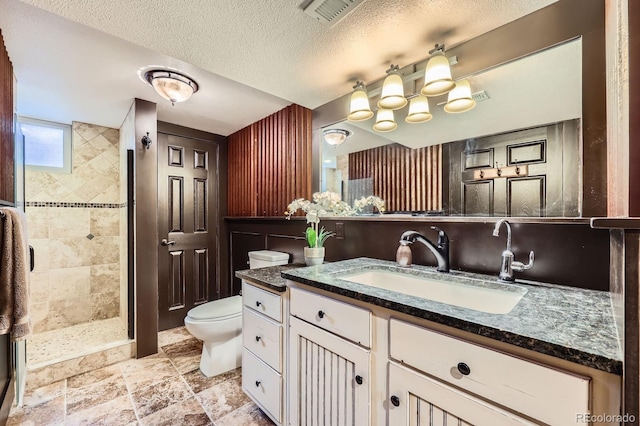 6646 S Fundy Ct, Centennial, CO 80016 - full bathroom featuring toilet, vanity, a stall shower, stone finish floors, and a textured ceiling