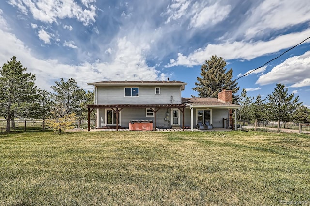 6646 S Fundy Ct, Centennial, CO 80016 - back of house with a hot tub, a patio, and a chimney