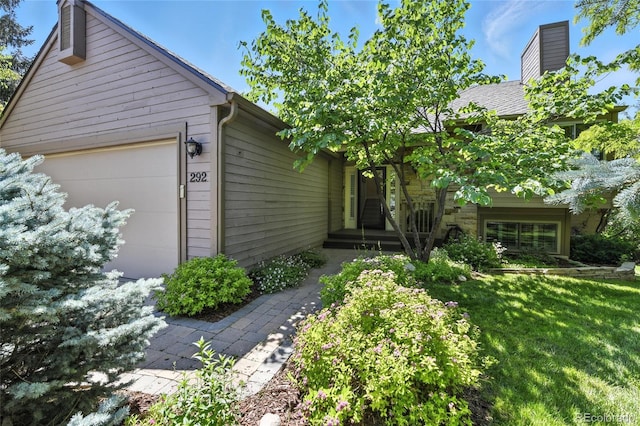 292 Summerwood Ln, Castle Pines, CO 80108 - view of front facade with a chimney, a front yard, and an attached garage