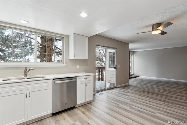 kitchen with ceiling fan, dishwasher, sink, a textured ceiling, and white cabinets