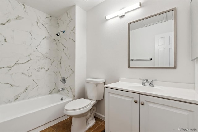 full bathroom with tile patterned floors, vanity, tiled shower / bath combo, and toilet