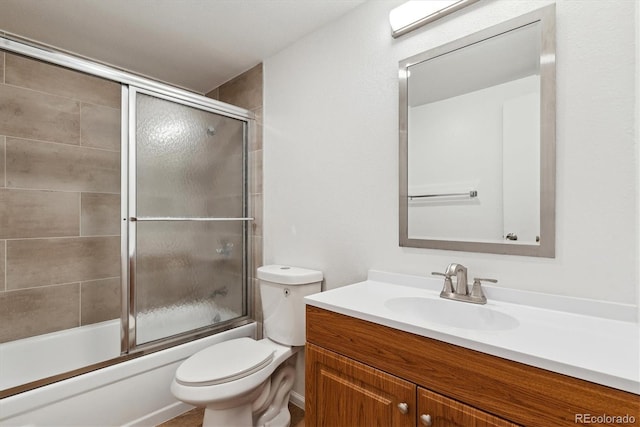 full bathroom with vanity, toilet, and bath / shower combo with glass door