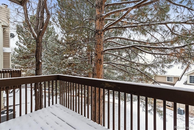 snow covered deck featuring central air condition unit