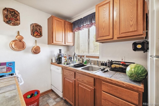 kitchen with sink, white dishwasher, and tile counters