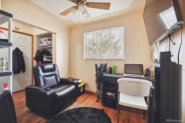 office area with light hardwood / wood-style flooring and ceiling fan