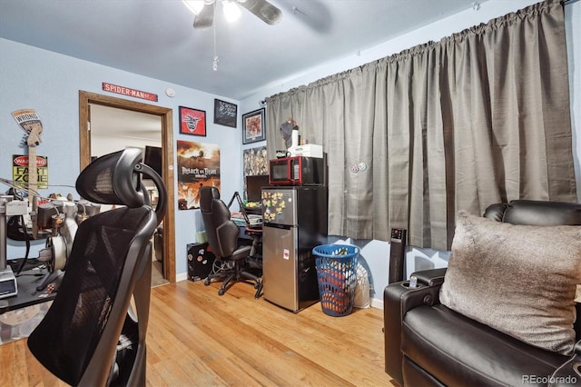 office with wood-type flooring and ceiling fan