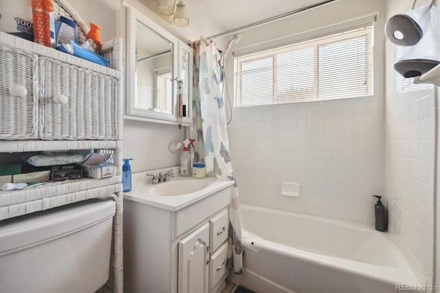 full bathroom with shower / tub combo with curtain, vanity, and toilet