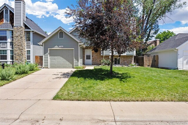 4786 S Yampa St, Aurora, CO 80015 - view of front of home featuring a garage, driveway, and brick siding