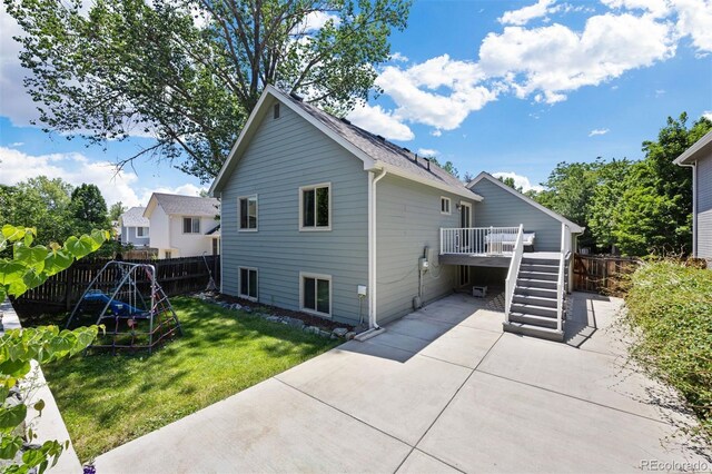 4786 S Yampa St, Aurora, CO 80015 - rear view of property with a patio area, a wooden deck, and stairs