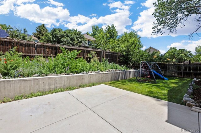 4786 S Yampa St, Aurora, CO 80015 - fenced backyard featuring a playground and a patio area
