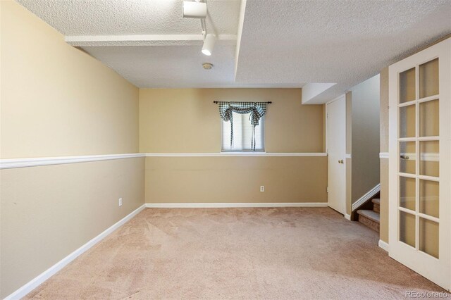 4786 S Yampa St, Aurora, CO 80015 - unfurnished room featuring a textured ceiling, carpet floors, a smoke detector, and stairway