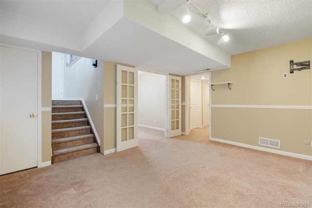 4786 S Yampa St, Aurora, CO 80015 - finished below grade area with carpet, a textured ceiling, stairs, and french doors