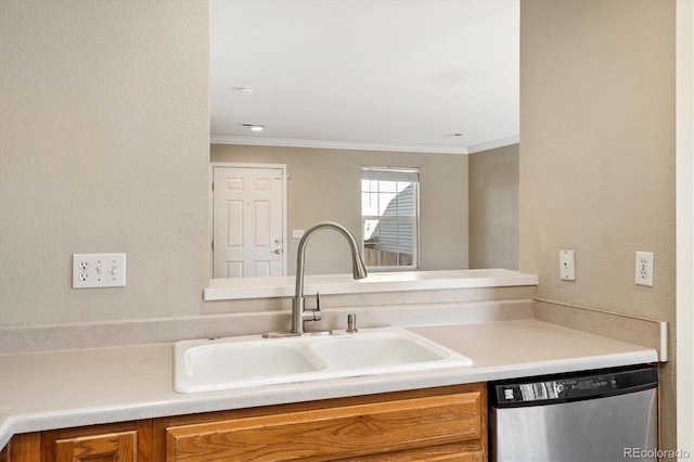 kitchen with stainless steel dishwasher, crown molding, and sink