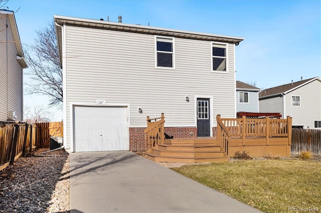 rear view of property with a yard, a deck, a garage, and central air condition unit