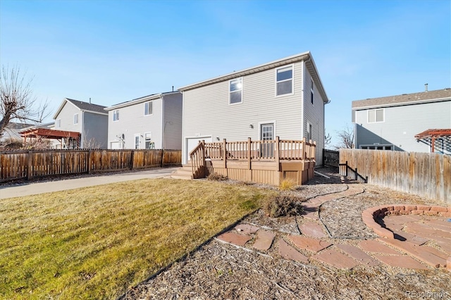 rear view of property featuring a deck and a lawn