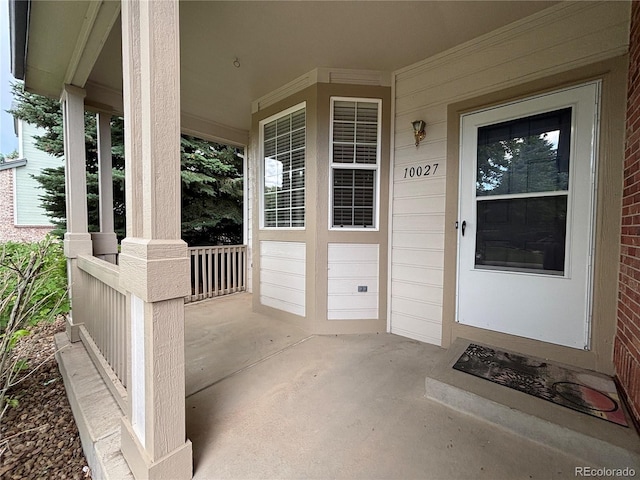 10027 Sylvestor Rd, Highlands Ranch, CO 80129 - view of exterior entry with a porch