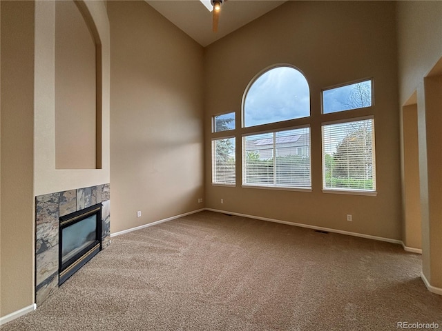 10027 Sylvestor Rd, Highlands Ranch, CO 80129 - unfurnished living room with carpet, high vaulted ceiling, and a glass covered fireplace