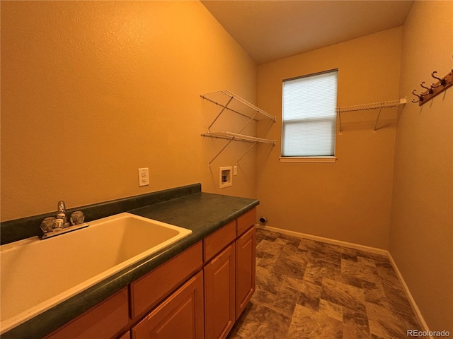 10027 Sylvestor Rd, Highlands Ranch, CO 80129 - laundry room with hookup for a washing machine, cabinet space, and stone finish flooring