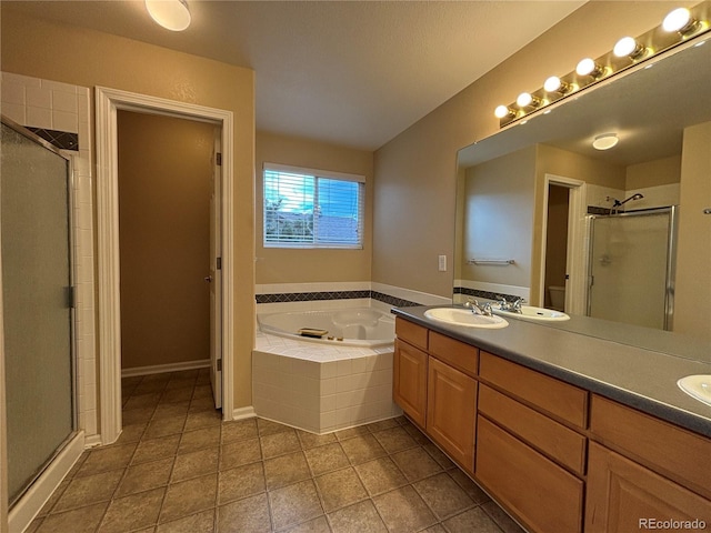 10027 Sylvestor Rd, Highlands Ranch, CO 80129 - full bath with a stall shower, double vanity, a garden tub, and tile patterned floors